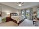 A relaxing main bedroom with a large window, decorative drapes, and a ceiling fan at 6507 Maiden Sea Dr, Apollo Beach, FL 33572