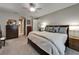 Spacious main bedroom offering a plush bed, a ceiling fan, and an arched entryway to the en suite bathroom at 6507 Maiden Sea Dr, Apollo Beach, FL 33572