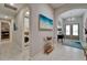 Welcoming entryway with double doors, a stylish console table and view to the laundry room at 6507 Maiden Sea Dr, Apollo Beach, FL 33572