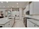 Open kitchen with white cabinets, a center island, and stainless steel appliances at 6507 Maiden Sea Dr, Apollo Beach, FL 33572