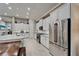 Bright kitchen featuring modern appliances, granite counters, and white cabinets at 6507 Maiden Sea Dr, Apollo Beach, FL 33572