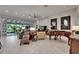 Spacious living room with a piano, comfortable seating, and view of the outdoor space at 6507 Maiden Sea Dr, Apollo Beach, FL 33572