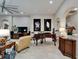 Stylish living room featuring a grand piano, large artwork, and comfortable armchairs at 6507 Maiden Sea Dr, Apollo Beach, FL 33572