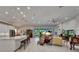 Open-concept living space with kitchen island, expansive windows, and stylish furniture at 6507 Maiden Sea Dr, Apollo Beach, FL 33572