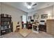Organized home office with built-in shelving, featuring a desk, chair and natural light at 6507 Maiden Sea Dr, Apollo Beach, FL 33572