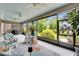 Enclosed patio showcasing comfortable seating and scenic backyard views through screened windows at 6507 Maiden Sea Dr, Apollo Beach, FL 33572