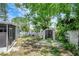 Spacious backyard featuring a storage shed, partially fenced perimeter, and a lush tree canopy at 6601 13Th N St, St Petersburg, FL 33702
