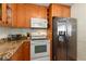Functional kitchen showcasing a stainless steel refrigerator, white appliances, and custom cabinets at 720 39Th N Ave, St Petersburg, FL 33703