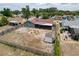 Aerial view of a home showcasing a spacious backyard with fire pit, screened in patio, and storage shed at 7237 Bramblewood Dr, Port Richey, FL 34668
