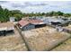 Birds eye view of the backyard, complete with fire pit, shed, and screened patio, enhancing outdoor living at 7237 Bramblewood Dr, Port Richey, FL 34668