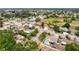 An aerial view captures a single-Gathering home nestled in a serene neighborhood with lush greenery and a tranquil atmosphere at 7237 Bramblewood Dr, Port Richey, FL 34668