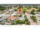 Aerial view showcasing a single-Gathering home in a peaceful neighborhood with mature trees and well-maintained streets at 7237 Bramblewood Dr, Port Richey, FL 34668