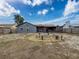 This expansive backyard features a custom fire pit, seating, and a screened in patio for outdoor enjoyment at 7237 Bramblewood Dr, Port Richey, FL 34668
