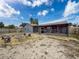 A spacious backyard featuring a fire pit with seating area and screened in patio, perfect for outdoor entertaining at 7237 Bramblewood Dr, Port Richey, FL 34668