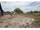 Large backyard with a fire pit and seating, enclosed by a privacy fence, ideal for outdoor gatherings at 7237 Bramblewood Dr, Port Richey, FL 34668