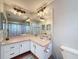 Bathroom features large mirrors, ample vanity counter space, and a toilet at 7237 Bramblewood Dr, Port Richey, FL 34668
