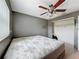 This bedroom features tiled floors, a ceiling fan, and a walk in closet at 7237 Bramblewood Dr, Port Richey, FL 34668