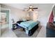 Bedroom with a ceiling fan, light gray walls, and light gray, patterned carpet at 7237 Bramblewood Dr, Port Richey, FL 34668