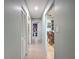 Hallway featuring tile floors and access to the bedrooms and living spaces at 7237 Bramblewood Dr, Port Richey, FL 34668