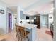 Open kitchen featuring an island with seating and stylish gray cabinetry at 7237 Bramblewood Dr, Port Richey, FL 34668