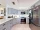 Stylish kitchen with gray cabinets, stainless steel appliances, and quartz countertops at 7237 Bramblewood Dr, Port Richey, FL 34668
