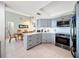 Eat-in kitchen featuring gray cabinets, stainless appliances, and a dining area at 7237 Bramblewood Dr, Port Richey, FL 34668