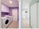 Laundry room with Samsung washer and dryer units and purple-painted walls and cabinets at 7237 Bramblewood Dr, Port Richey, FL 34668