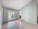 Bright living room featuring tile floors, vaulted ceilings, and sliding glass doors to the outdoor patio at 7237 Bramblewood Dr, Port Richey, FL 34668
