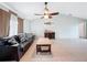 Comfortable living room with a ceiling fan, couch, and tile flooring for easy maintenance at 7237 Bramblewood Dr, Port Richey, FL 34668