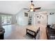 Bright living room with tile floors, a ceiling fan, and access to outdoor space at 7237 Bramblewood Dr, Port Richey, FL 34668