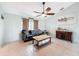 Cozy living room with tile floors, a ceiling fan, and plenty of natural light at 7237 Bramblewood Dr, Port Richey, FL 34668