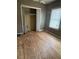Empty bedroom featuring plywood flooring and closet at 7807 N Mulberry St, Tampa, FL 33604