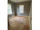 Empty bedroom with plywood flooring and window at 7807 N Mulberry St, Tampa, FL 33604