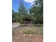 A single Gathering home with a chain link fence is surrounded by trees at 7807 N Mulberry St, Tampa, FL 33604