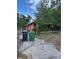 Exterior view of red house and gate with trash cans visible at 7807 N Mulberry St, Tampa, FL 33604