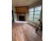 A living room features a fireplace with wood flooring and a large window at 7807 N Mulberry St, Tampa, FL 33604