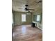 Living room with bare walls, wooden floors, and large mirror at 7807 N Mulberry St, Tampa, FL 33604