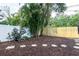 Large backyard featuring a white privacy fence and beautiful, mature trees at 7842 15Th N Way, St Petersburg, FL 33702