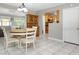 Bright dining room area with tile floors, modern light fixture, and convenient flow to the kitchen at 7842 15Th N Way, St Petersburg, FL 33702