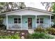 Charming single-story home with a quaint front porch, lush landscaping, and a welcoming entrance at 7842 15Th N Way, St Petersburg, FL 33702