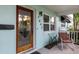 Inviting front porch with seating, showcasing the entrance and natural light from the windows at 7842 15Th N Way, St Petersburg, FL 33702