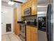 Galley kitchen boasting stainless steel appliances, granite countertops, and sleek, wooden cabinets at 7842 15Th N Way, St Petersburg, FL 33702