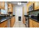 Galley kitchen featuring granite countertops, stainless steel appliances, and stylish backsplash for a modern touch at 7842 15Th N Way, St Petersburg, FL 33702