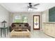 Living area featuring tile flooring, a ceiling fan, a comfortable sofa, and great natural light at 7842 15Th N Way, St Petersburg, FL 33702
