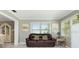 Cozy living room with a leather sofa, neutral walls, and a view of the dining area and kitchen at 7842 15Th N Way, St Petersburg, FL 33702