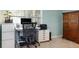 Bright home office with desk, rolling chair and a large armoire at 7842 15Th N Way, St Petersburg, FL 33702