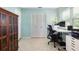 Well-lit home office with a large desk, rolling chair, and storage at 7842 15Th N Way, St Petersburg, FL 33702