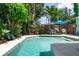 Beautiful pool area surrounded by lush landscaping and patio furniture at 7842 15Th N Way, St Petersburg, FL 33702