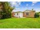 Fenced backyard with green grass and mature landscaping at 8225 Medford Dr, Port Richey, FL 34668