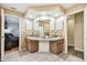 This bathroom features a dual sink vanity, tile floors, and neutral decor at 8225 Medford Dr, Port Richey, FL 34668